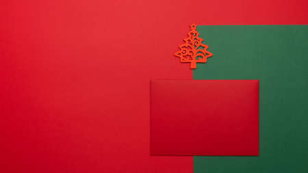 Festive background with Christmas tree toy, red envelope. Festive background with copyspace.の写真素材