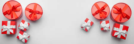 Celebratory lighten background with ten red gift boxes. Christmas background with copy space. Holiday concept. Banner.の写真素材