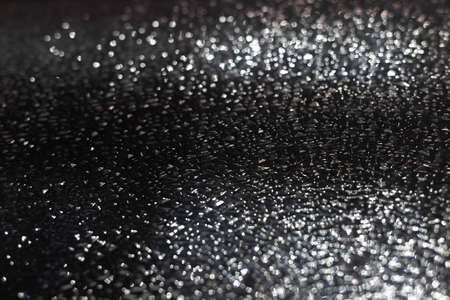 Abstract background of glass transparent texture. Bright shiny backdrop. Defocused. Blurred bokeh. Party, holiday and festive concept.の写真素材