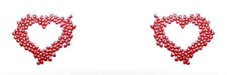 Valentine day isolated white background with red candies hearts. Concept of love, marriage, wedding, Valentine's day, passion. Top view. Banner.の写真素材