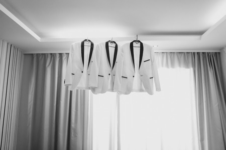 business man suit clothes hanging. groom jacket.