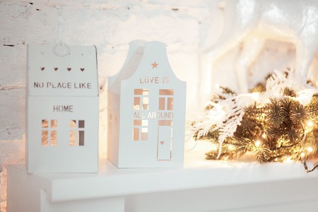 Christmas candle houses. Burning lantern and xmas decoration on white background.