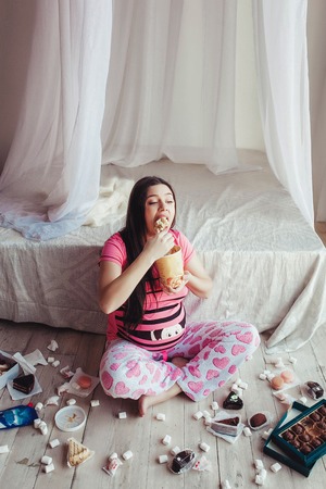 Pretty cute pregnant woman eating ice creamの写真素材