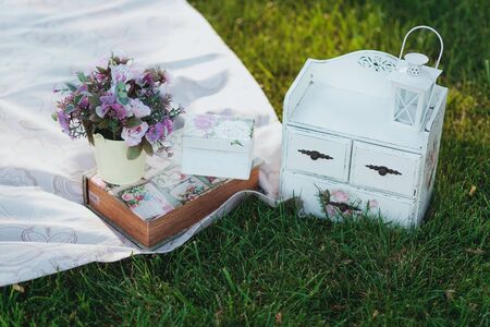 Flowers in a bucket. Picnic on a grass