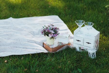 Flowers in a bucket. Picnic on a grassの写真素材