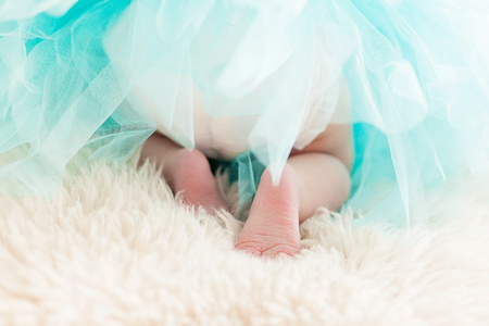 Newborn baby in turquoise dress back shot.の写真素材