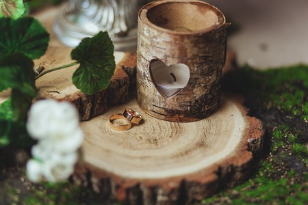 wedding rings on the stump in a green grassの写真素材