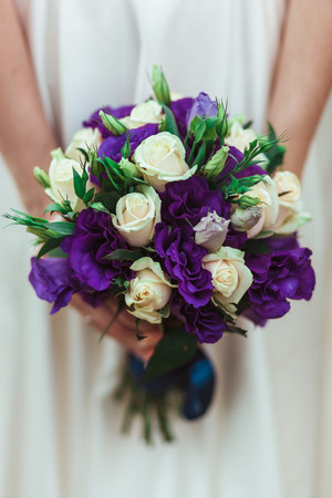 Bride holding wedding bouquet flowersの写真素材