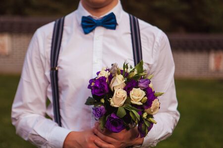 Gorgeous smiling groom. andsome groom at wedding tuxedo waiting for bride.Elegant man in white shirt and bow-tie.の写真素材