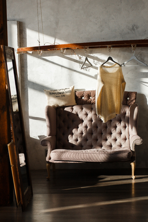 Dressing room with shoulder rack and sofa. Modern loft interior.の写真素材