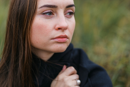 portrait of cheerful beautifull young caucasian woman portrait in forest. Close-up vertical shotの写真素材