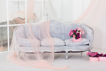 Luxury sofa in white interior with flower bouquetの写真素材