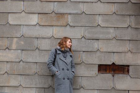 Young tender woman on gray brick background. Rusty wallの写真素材