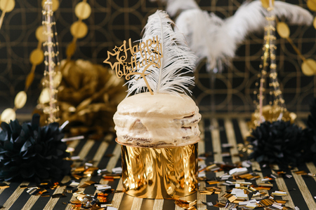 Birthday party cake with golden and black decor various balloons. Happy birthday signの写真素材