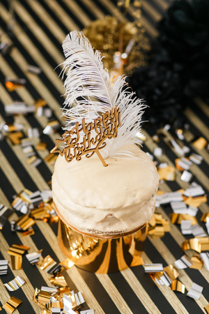 Birthday party cake with golden and black decor various balloons. Happy birthday signの写真素材
