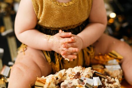 Babys hands in cake close shot. Birthday partyの写真素材