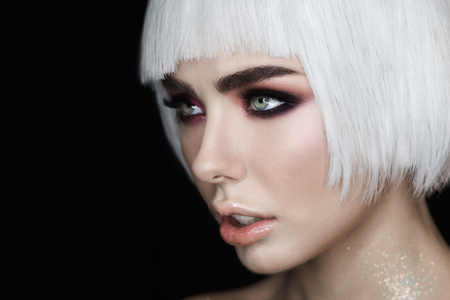 Side view portrait. Sexy blonde woman model with makeup, cheekbones and healthy shiny skin. Evening glamour style, fashion make-upの写真素材