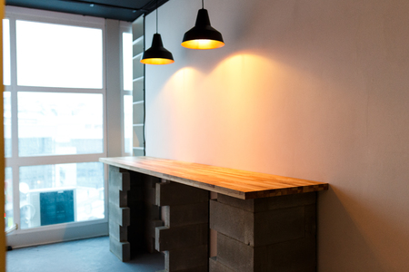 Office kitchen with wooden table and modern edison light. Minimalistic loft designの写真素材
