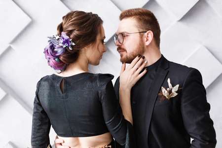 Sensual portrait of couple close-up. Wedding photography on gray geometric backgroundの写真素材