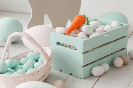 White easter eggs in painted wooden boxの写真素材