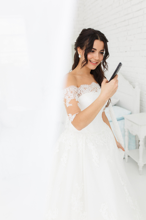 A bride talking on a mobile phoneの写真素材