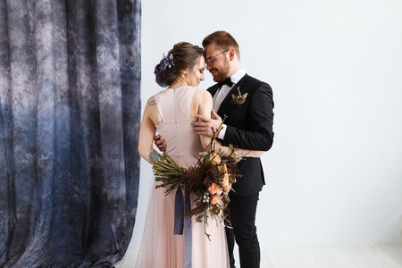 bride and groom full-lenght portrait in studioの写真素材