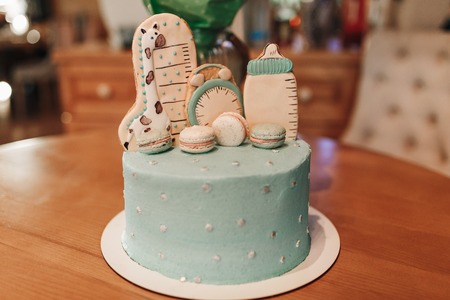 Pastel color decoration of a first year birthday cake on wooden table.の写真素材