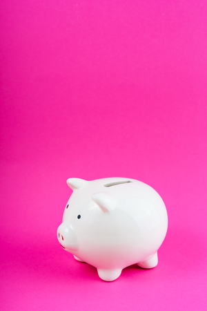 White Money Save Pig on Pink Background Copy Spaceの写真素材