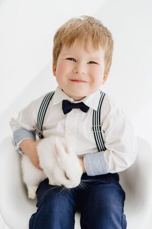 Caucasian Little Boy Posing with Rabbit Portraitの写真素材