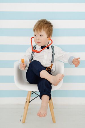 Caucasian Boy with Stethoscope Playing Doctorの写真素材