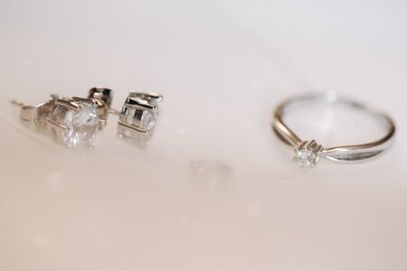 Ring and Earrings with Diamond on White Background