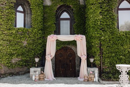 Arch for Ceremony Decorated Pink Flower and Clothの写真素材