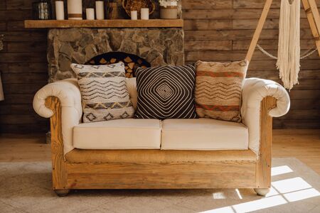 Wooden Sofa in Chalet Cozy Interior with Fireplaceの写真素材