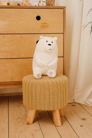 White Teddy Bear Toy in Clean Baby Room Backgroundの写真素材