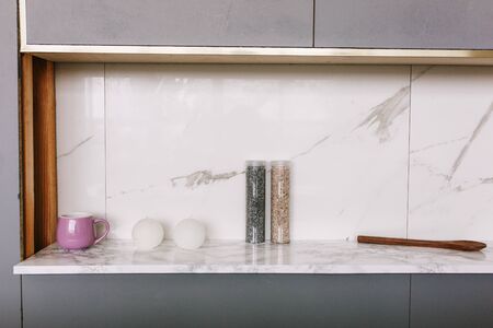 Kitchen marble bench close up with two candles and salt bottles or decor stonesの写真素材