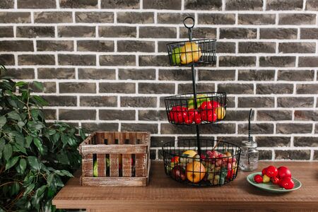 Fruit basket in loft style kitchen with vintage brick wall backgroundの写真素材