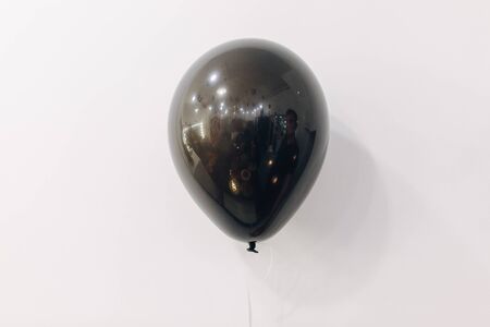 Blank black balloon mock up isolated on white wall backgroundの写真素材