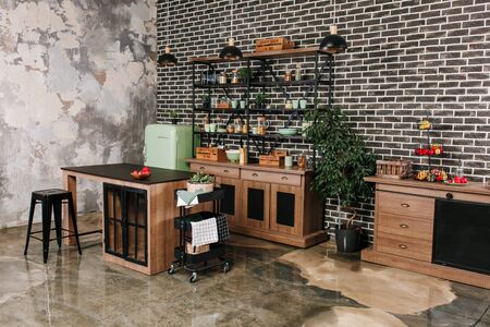 Dining area in industrial style with table, chairs and mint retro fridge. Black vintage brick wall backgroundの写真素材