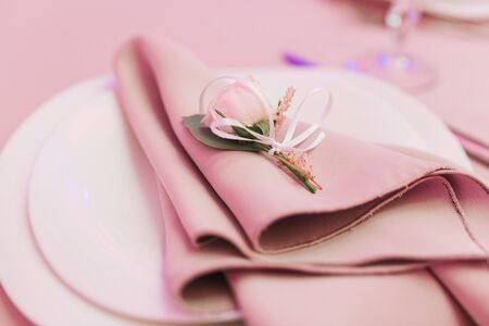 Dining table setting at Provence style, with small rose flower, beige napkin. Close-up horizontal viewの写真素材