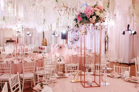 Table 8 set for wedding or another catered event dinner. Luxury decorated with natural flowersの写真素材