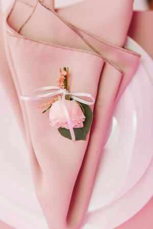 Dining table setting at Provence style, with small rose flower, beige napkin. Close-up horizontal viewの写真素材