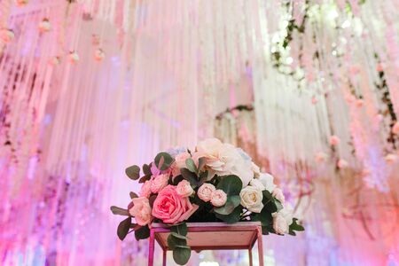 Decorated wedding hall. Luxury flower bouquet and ceiling decorの写真素材