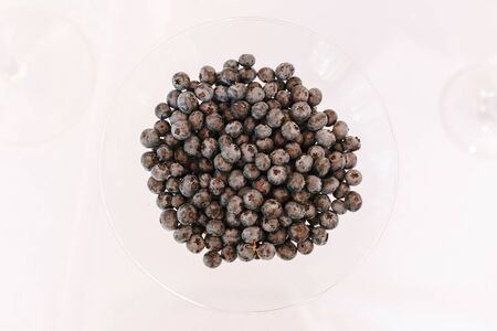 blueberries, Vaccinium corymbosum in glass isolated on white table backgroundの写真素材