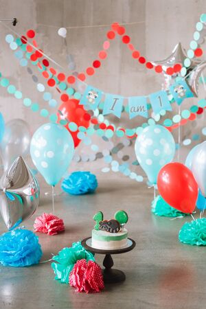 Baby first birthday cake in decorated studio roomの写真素材