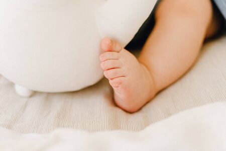 Partial View of Cute Baby Leg Sleeping in Bedの写真素材