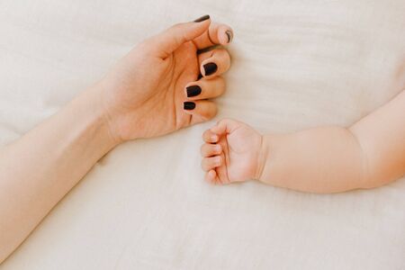 Mother and Tiny New Born Baby Arm Partial Viewの写真素材