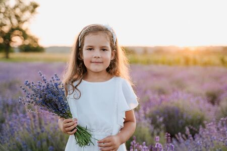 Beautiful Little Girl with Bouquet of Lavenderの写真素材