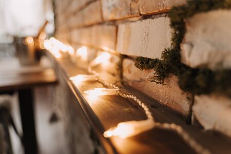 Christmas Glowing Garland Lights on Wooden Shelfの写真素材