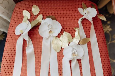 Flower Buds Decorated Golden Leaves and Ribbonsの写真素材