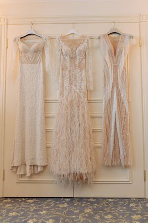 Elegant Fashion Wedding Dresses Hanging on Doorの写真素材